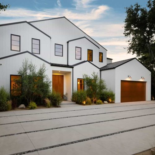 Modern white house exterior with wooden accents.